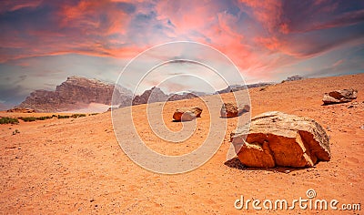 Red sky, sands and stones of Wadi Rum desert Stock Photo