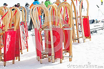 Red sledges and ski people Stock Photo
