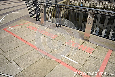 Red smoking zone marked on a bridge Editorial Stock Photo