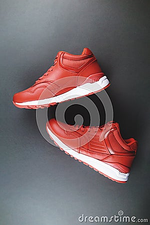 Red sneakers on gray background. Concept of sport and healthy lifestyle. Stock Photo