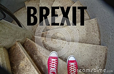 Red sneakers on spiral staircase when going downhill with inscription Brexit symbolizing the withdrawal of Great Britain from the Stock Photo