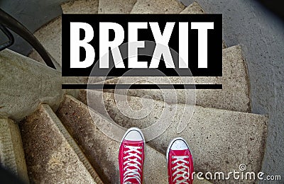 Red sneakers on spiral staircase when going downhill with inscription Brexit symbolizing the withdrawal of Great Britain from the Stock Photo