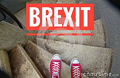 Red sneakers on spiral staircase when going downhill with inscription Brexit symbolizing the withdrawal of Great Britain from the Stock Photo