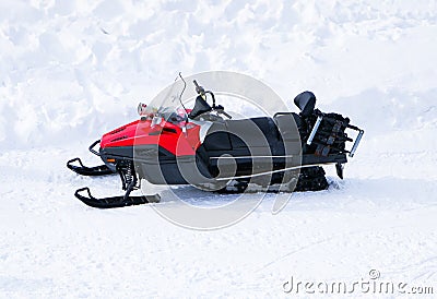 Red Snowmobile ski-doo. Skidoos parking in the snow-white yard. Stock Photo