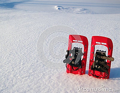 Red snowshoes in snow Stock Photo