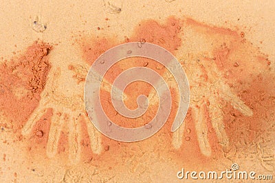 Red soil hand shape on sand in aboriginal art style Stock Photo