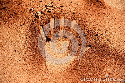 Red soil hand shape on sand like aboriginal art style Stock Photo