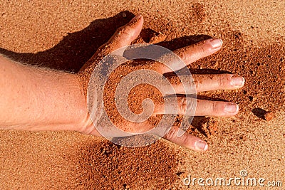 Red soil hand shape on sand like aboriginal art style Stock Photo
