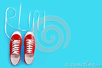 Red sports shoes sneakers with white laces and the word run Stock Photo