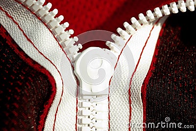 Red sportswear closeup top view. white zip line on the wrong side. breathable knitwear. clothing details macro Stock Photo