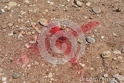 Red spray paint is sprayed as a cross on the nail head for marking the location. Stock Photo