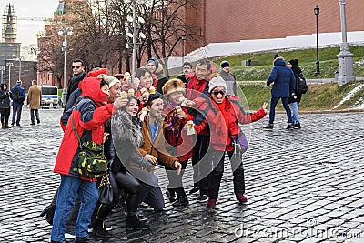 Red Square. A group of cheerful tourists and travelers are photographed with a delicious ice cream in memory of Russia. Editorial Stock Photo