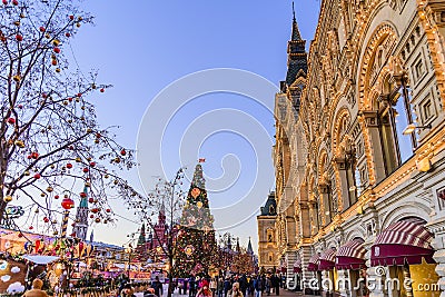Red Square, GUM. People, Christmas tree and decorated trees near GUM in Christmas and New Year. Moscow, Russia. Editorial Stock Photo