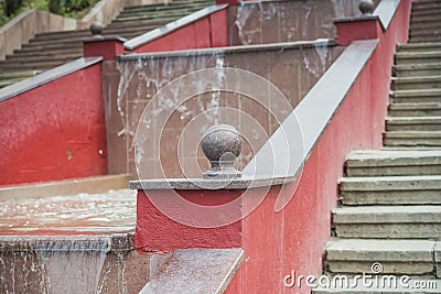 Red staircase with a fountain in the middle Stock Photo