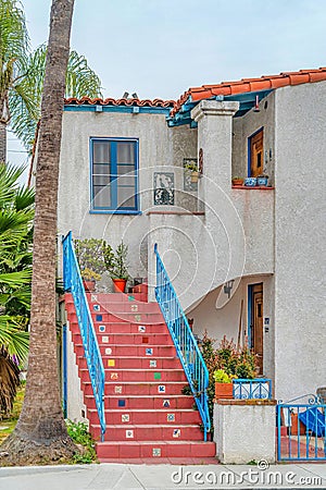 Red stairs with blue handrails at the facade of house in Long Beach California Stock Photo