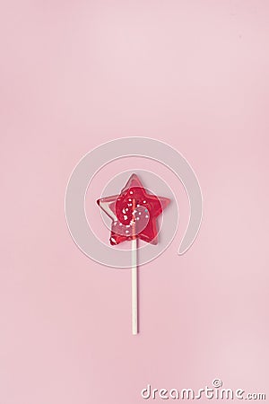 Red Star Shaped Lollipop on Light Pink Background Homemade Fruit Lollipop Candy Background Flat Lay Top View Vertical Stock Photo