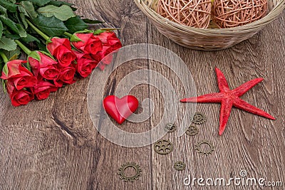 Red starfish, heart and red roses on a table Stock Photo