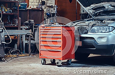 Red tool box in a garage. Stock Photo