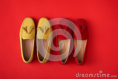 Red suede woman`s mocassin shoes over red background Stock Photo