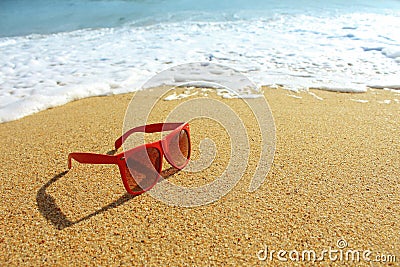 Red sunglasses on the beach Stock Photo