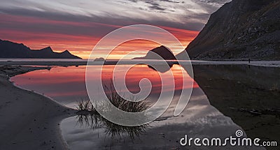 sunset reflected in the water on a paradise beach Haukland with white sand, and mountains the Lofoten Islands in polar Norway Stock Photo