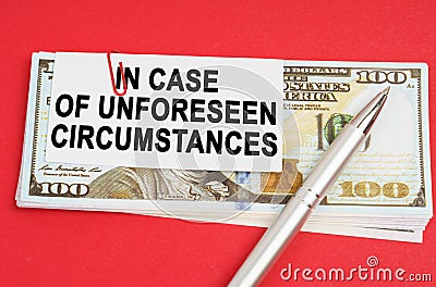 On a red surface are dollars on which a pen and paper with the inscription - in case of unforeseen circumstances Stock Photo