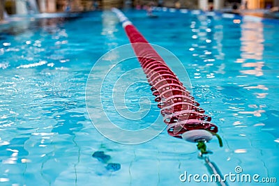 Red Swimming Lane Marker in swimming pool.Color-fast swimming pool lane line.Lane ropes in swimming pool.red plastic Stock Photo