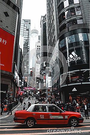 Red taxi waiting on a crosswalk in Hong Kong Island in China Editorial Stock Photo