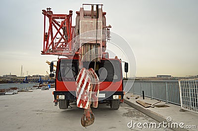 Red telescopic crane, road works Stock Photo