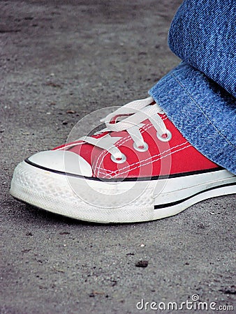 Red tennis shoe and jeans Stock Photo