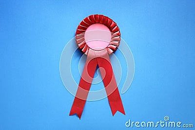 Red award rosette with ribbons Stock Photo