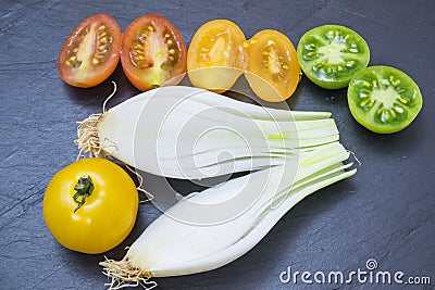 Red tomatoes, yellow and scallions Stock Photo