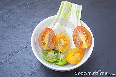 Red tomatoes, yellow and scallions Stock Photo