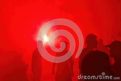 Red smoke black people silhouette protest demonstration Stock Photo