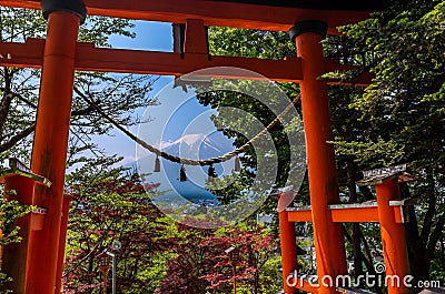 Red tori with Mount Fuji in the background at Chureito pagoda Stock Photo