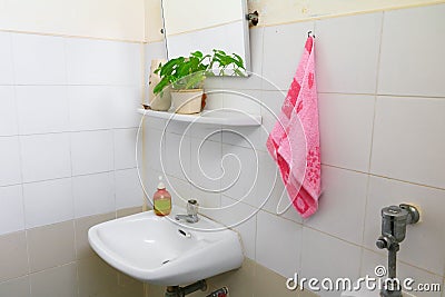 Red towel for wipe hand in toliet room on wall Stock Photo