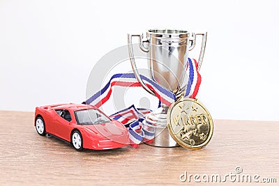 Red toy car with silver sporting trophy Stock Photo