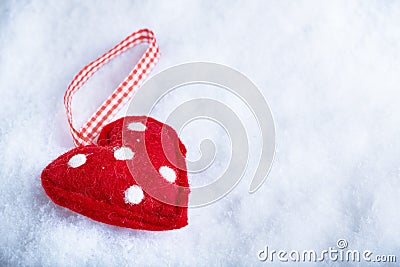 Red toy suave heart on a frosty white snow winter background. Love and St. Valentine concept Stock Photo