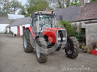 Red Tractor on Farmyard Stock Photo