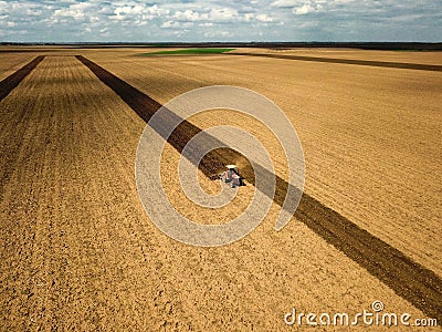 Red tractor plow the field Stock Photo