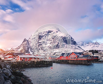 Red traditional rorbuer in small village at sunset in winter Stock Photo