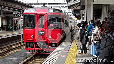 Red train approaching train station Editorial Stock Photo