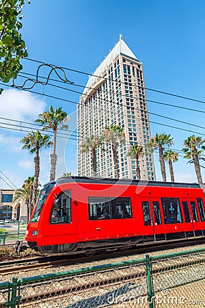 Red Train in front of city building, San Diego Editorial Stock Photo