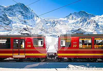 Red train of Jungfrau Bahn at Kleine Scheidegg station Editorial Stock Photo