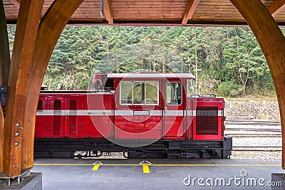 Red train on railway forest in Alishan National Scenic Area Stock Photo