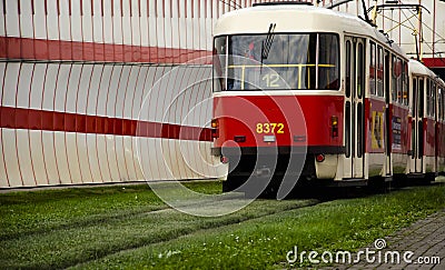 Red tram at the stop in the european city Editorial Stock Photo