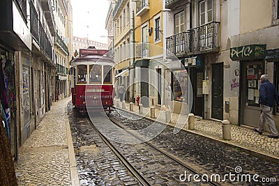 A red tram to the narrow streets of Lisbon Editorial Stock Photo