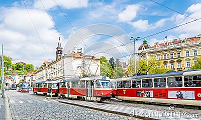 Red trams on the ancient streets of Prague. City Life in Europe Editorial Stock Photo