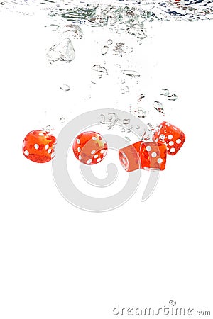 Red transparent dice falling into the water Stock Photo