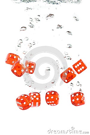 Red transparent dice falling into the water Stock Photo